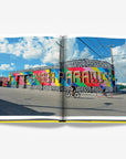 Bold and colorful Miami street art mural with 'Remember Paradise' painted across a lively urban wall. A stunning feature from the Assouline Coffee Table Book Miami Beach, available at Spacio India.