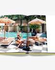 A luxurious Miami poolside retreat with sunbeds, cabanas, and lush tropical greenery, perfect for an indulgent getaway. From the Assouline Coffee Table Book Miami Beach, available at Spacio India.