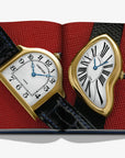 Close-up image from Assouline’s Fine Timepieces Book displaying two vintage Cartier luxury watches with distinctive artistic designs, available online at Spacio India.