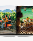 Colourful pictures on a double spread in a luxurious Assouline Wine & Travel France coffee table book featuring France’s finest vineyards and wine regions, available at Spacio India retail stores and online.