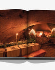 A dining table on a double spread in a luxurious Assouline Wine & Travel France coffee table book featuring France’s finest vineyards and wine regions, available at Spacio India retail stores and online.