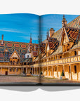 A colourful double spread in a luxurious Assouline Wine & Travel France coffee table book featuring France’s finest vineyards and wine regions, available at Spacio India retail stores and online.