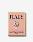 On a white background. A luxurious hardbound Assouline coffee table book, Wine & Travel Italy, featuring Italy’s top vineyards, fine wines, and the art of winemaking.