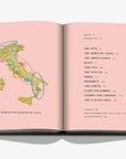 Double spread of the harvesting regions of Italy. A luxurious hardbound Assouline coffee table book, Wine & Travel Italy, featuring Italy’s top vineyards, fine wines, and the art of winemaking.
