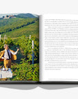 Vineyard photograph on a double spread of a luxurious hardbound Assouline coffee table book, Wine & Travel Italy, featuring Italy’s top vineyards, fine wines, and the art of winemaking.