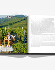 Vineyard photograph on a double spread of a luxurious hardbound Assouline coffee table book, Wine & Travel Italy, featuring Italy’s top vineyards, fine wines, and the art of winemaking.