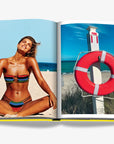 Miami Beach Lifestyle Photography Spread – A woman enjoying the sun on a beach and a classic red lifebuoy, featured in Assouline’s Miami Beach book. Shop this collectible edition at Spacio India.