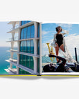 Modern luxury beachfront apartment with sleek glass balconies overlooking the ocean, capturing the architectural elegance of Miami. Available in the Assouline Coffee Table Book Miami Beach at Spacio India.