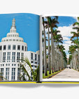 Iconic Miami Art Deco building with white geometric architecture and palm tree-lined avenues, representing the city's architectural legacy. Captured in the Assouline Coffee Table Book Miami Beach, available at Spacio India.