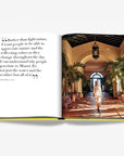 Serene courtyard with lush tropical greenery and classic Spanish-inspired arches, bathed in golden sunlight. Part of the Assouline Coffee Table Book Miami Beach, available at Spacio India.