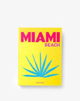 On a white background a luxurious Miami Beach coffee table book by Assouline, featuring vibrant photography and elegant design, available at Spacio India for collectors and decor enthusiasts.