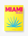 On a white background a luxurious Miami Beach coffee table book by Assouline, featuring vibrant photography and elegant design, available at Spacio India for collectors and decor enthusiasts.