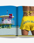 A double spread of featuring a vibrant South Beach scene with a lifeguard tower and a person in yellow shorts in a luxurious Miami Beach coffee table book by Assouline, featuring vibrant photography and elegant design, available at Spacio India for collectors and decor enthusiasts.