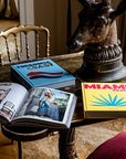 Luxury Coffee Table Books on Display – Assouline Miami Beach and Turquoise Coast coffee table books elegantly displayed on a luxury decor table. Elevate interiors with Spacio India.