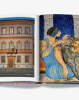 A historic Italian building with ornate windows and a balcony and a colorful mosaic depicting a classical scene of a woman cutting a man's hair on a double spread in a luxurious Assouline Milan Chic coffee table book, showcasing Milan’s timeless elegance, now available at Spacio India’s online store and retail outlets.