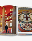 A double spread of a milan’s architectural elegance, featuring a grand interior with red ceiling and a historic mosaic in a luxurious Assouline Milan Chic coffee table book, showcasing Milan’s timeless elegance, now available at Spacio India’s online store and retail outlets.