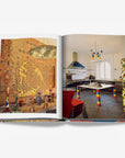 A vibrant interior spread featuring an artistic dining space with a golden mosaic wall and a colorful, modern kitchen with eclectic design elements on a double spread in a luxurious Assouline Milan Chic coffee table book, showcasing Milan’s timeless elegance, now available at Spacio India’s online store and retail outlets.