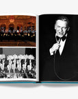 A double spread elegant performance with glowing lights, vintage showgirls in feathered costumes and singer performing in a luxurious Assouline's Monte Carlo coffee table book, featuring a vibrant cover with images of Monaco's iconic landmarks, available at Spacio India.