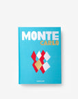 Front cover page of a luxurious hardbound Assouline's Monte Carlo coffee table book, featuring a vibrant cover with images of Monaco's iconic landmarks, available at Spacio India.