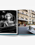 Luxury featuring a black-and-white portrait of an elegant woman in a car and a stunning shot of the iconic Hotel de Paris with a classic Rolls-Royce in double spread page of a luxurious Assouline's Monte Carlo coffee table book, featuring a vibrant cover with images of Monaco's iconic landmarks, available at Spacio India.