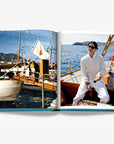Double spread page of a classic vintage yacht scene and a stylish man in white enjoying a sailing experience on a wooden boat in luxurious Assouline's Monte Carlo coffee table book, featuring a vibrant cover with images of Monaco's iconic landmarks, available at Spacio India.