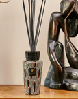 Baobab Collection Panya Diffuser 500ml displayed on a wooden table with artistic decor, featuring a striking African-inspired design. Available at Spacio India.