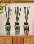 Baobab Panya and African-themed diffusers displayed together, featuring intricate ethnic prints. A luxury fragrance piece for home styling, available at Spacio India.