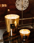 Pair of Baobab Aurum Candles lit on luxury wood table - exclusive fragrance experience from Spacio India