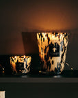 Baobab Black Pearls Candles Max 10 and larger size illuminated softly against dark background, evoking cosy elegance, available at Spacio India.