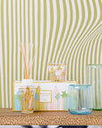 Miami My First Baobab candle and diffuser set styled against a modern patterned wall, highlighting its glass container and refreshing aroma, offered by Baobab at Spacio India