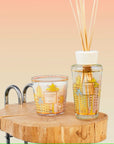 Stylish display of Baobab Miami candle and diffuser set placed on rustic wooden table, glass containers reflecting Miami's iconic architecture, featuring fresh cypress and pine aroma, from Spacio India