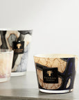 Close-up of Baobab Stones Lazuli Candle Max 10 in a designer setting, featuring striking blue and beige marble-like glass. Premium candle with musk and sea salt aroma at Spacio India.