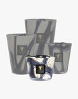 Collection of Baobab Stones Lazuli Candles in various sizes, showing the intricate marbled glasswork inspired by Tanzanian blue stones. Available at Spacio India retail stores and online.