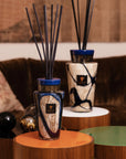Baobab Stones Lazuli Diffuser Totem elegantly placed in luxurious interior decor setting, highlighting sophisticated blue and gold glass design, available at Spacio India.