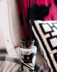 Close-up of Baobab Stones Marble Diffuser Totem 2L elegantly styled within an interior setting, highlighting the exquisite marble-patterned glass diffuser available at Spacio India retail stores and online.