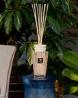 Baobab White Pearl Diffuser beautifully styled outdoors against lush greenery, offering a discreet fragrance of white musk and freesia; available at Spacio India retail stores.