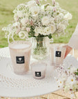 Set of Baobab White Pearls Candles in varying sizes, featuring delicate floral notes of freesia and white musk in hand blown glass, Spacio India.