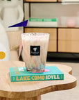 Baobab White Pearls Candle Max 16 styled on a wooden table, exuding luxury home decor with white musk and freesia fragrance, Spacio India exclusive.
