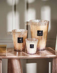 Collection of Baobab White Pearls candles in various sizes, placed on a marble console – luxury scented decor available at Spacio India.