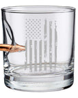 Clear whiskey glass with American flag engraving and bullet on a white background from the American brand Benshot available at Spacio retail stores in Mumbai & Kolkata.