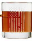 Clear glass with American flag design filled with bourbon whiskey on a white background
