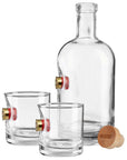 Clear whiskey decanter and two glasses with shotgun shell on a white background from the American brand Benshot available at Spacio retail stores in Mumbai & Kolkata.
