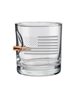 Clear whiskey glass with American flag engraving and a bullet casing on a white background from the American brand Benshot available at Spacio retail stores in Mumbai & Kolkata.