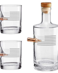 Clear whiskey glass decanter and two glasses with bullet on a white background from the American brand Benshot available at Spacio retail stores in Mumbai & Kolkata.