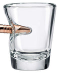 Clear glass shot glass with a bronze bullet on a white background from the American brand Benshot available at Spacio retail stores in Mumbai & Kolkata.