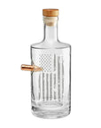 Clear whiskey decanter with a wooden cap and real bullet on a white background from the American brand Benshot available at Spacio retail stores in Mumbai & Kolkata.