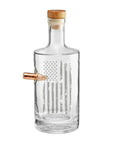 Clear whiskey decanter with a wooden cap and real bullet on a white background from the American brand Benshot available at Spacio retail stores in Mumbai & Kolkata.