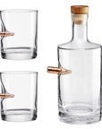 Clear glass whiskey decanter and two glasses with bullet on a white background from American brand Benshot available at Spacio retail stores in Mumbai & Kolkata.