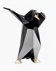 Black and gold penguin sculpture on a white background