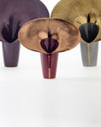 Three decorative vases with unique designs on a white background